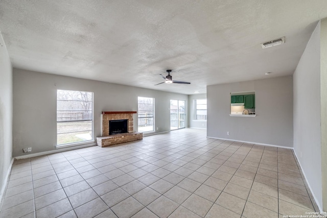 unfurnished living room featuring light tile patterned flooring, a fireplace, and ceiling fan