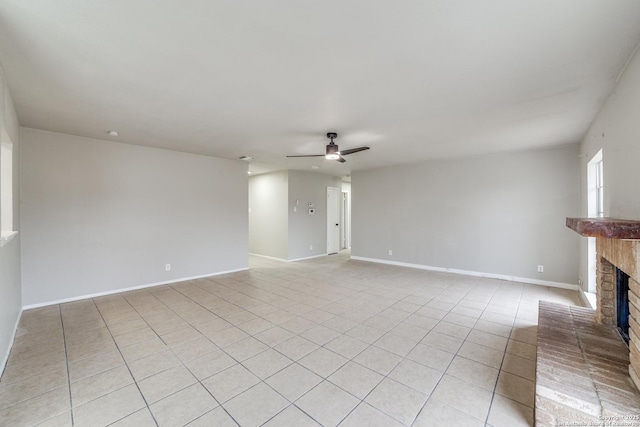 unfurnished living room with ceiling fan, light tile patterned floors, and a fireplace