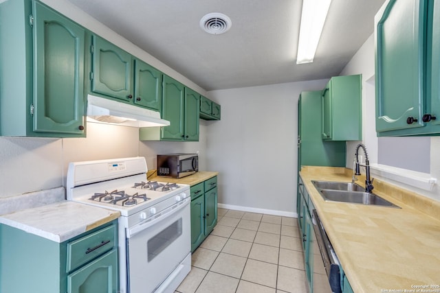 kitchen with dishwasher, sink, green cabinets, light tile patterned floors, and white gas stove