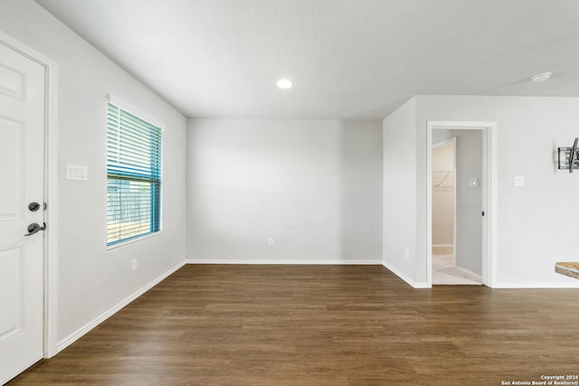 empty room with dark wood-type flooring