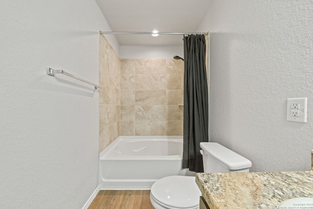 full bathroom with vanity, hardwood / wood-style floors, shower / bathtub combination with curtain, and toilet