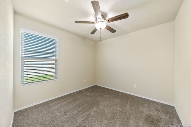 carpeted spare room with ceiling fan