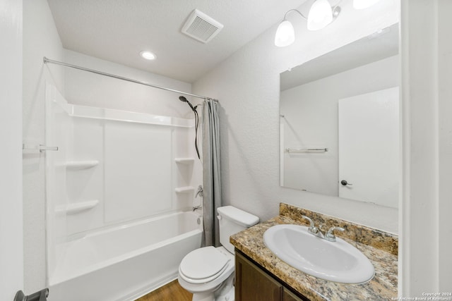 full bathroom featuring toilet, a textured ceiling, vanity, shower / bath combination with curtain, and hardwood / wood-style floors