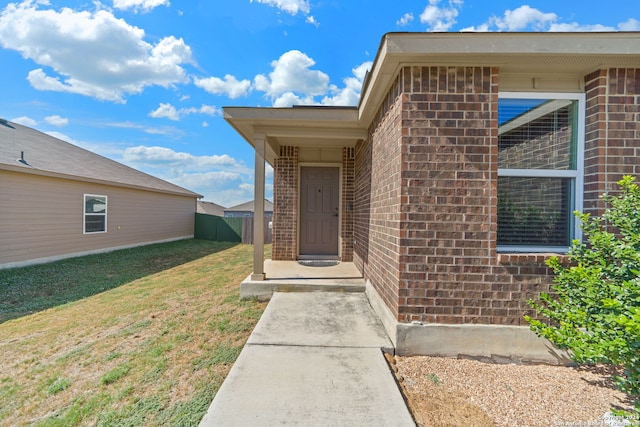 entrance to property with a yard