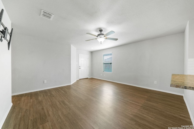 spare room with dark hardwood / wood-style floors and ceiling fan