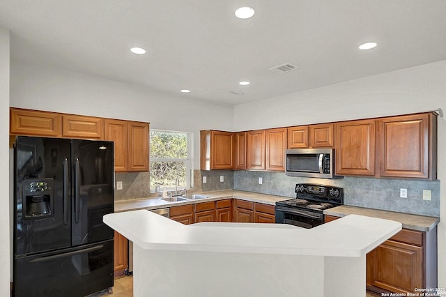 kitchen with sink, backsplash, and black appliances