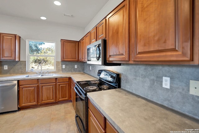 kitchen with tasteful backsplash, stainless steel appliances, sink, and light tile patterned floors