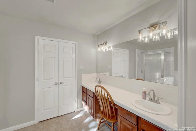 bathroom with vanity, tile patterned flooring, and a shower with door