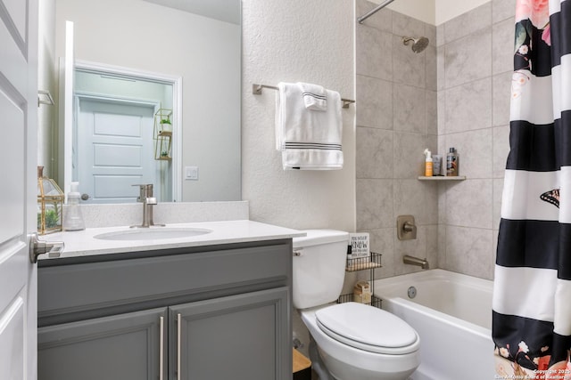 full bathroom featuring vanity, shower / bath combo with shower curtain, and toilet