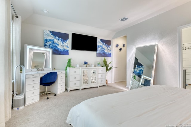 bedroom featuring lofted ceiling and light carpet