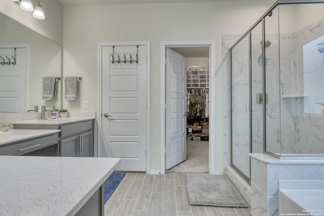 bathroom with vanity and independent shower and bath