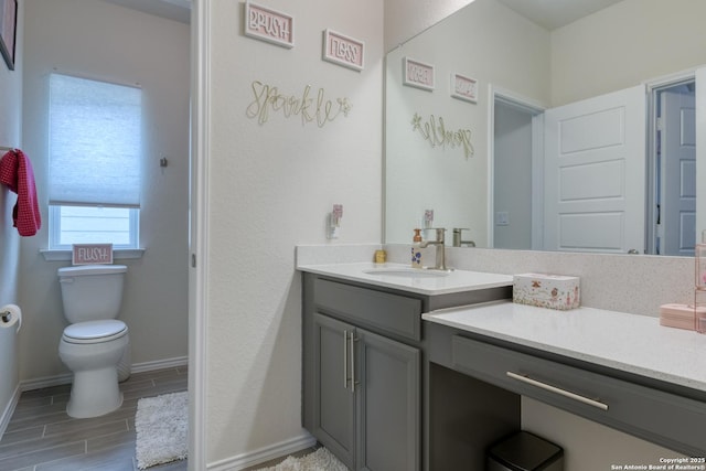 bathroom featuring vanity and toilet