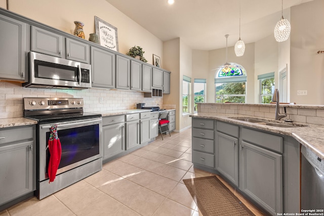 kitchen with sink, gray cabinets, and stainless steel appliances