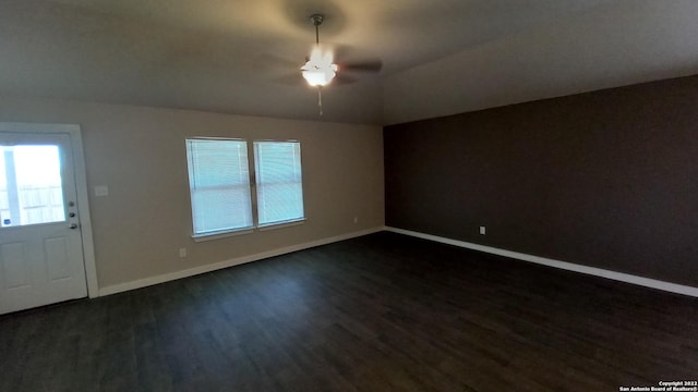 interior space with ceiling fan, dark hardwood / wood-style floors, and vaulted ceiling