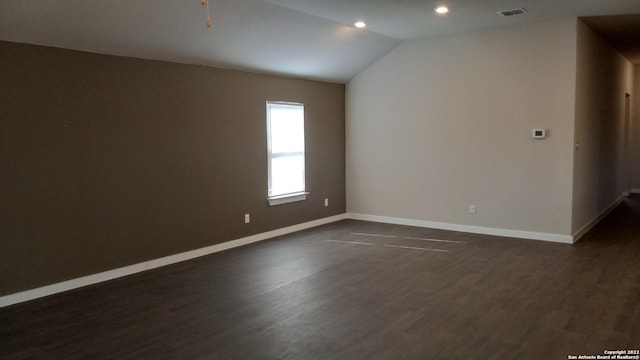 unfurnished room with lofted ceiling and dark hardwood / wood-style flooring