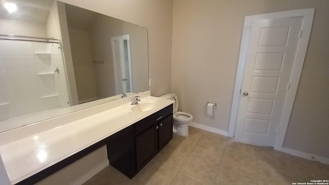 bathroom with vanity, a shower, tile patterned floors, and toilet