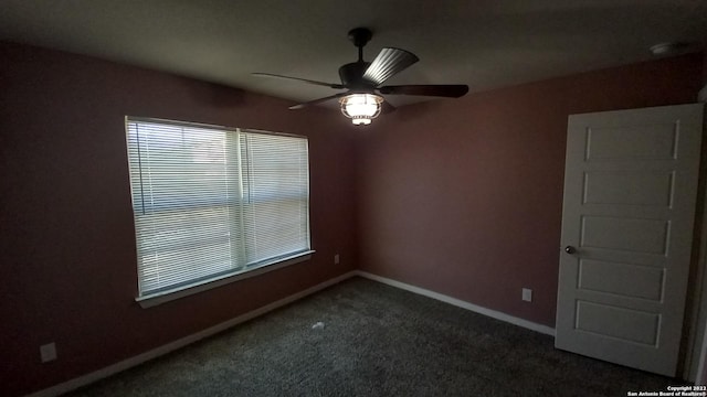 carpeted spare room featuring ceiling fan