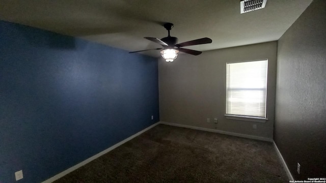 carpeted spare room with ceiling fan