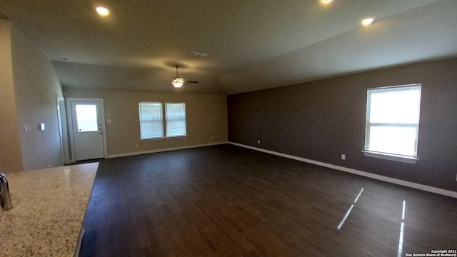 unfurnished room with lofted ceiling, dark hardwood / wood-style flooring, and ceiling fan