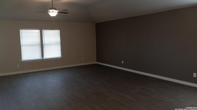 spare room with vaulted ceiling, dark hardwood / wood-style floors, and ceiling fan