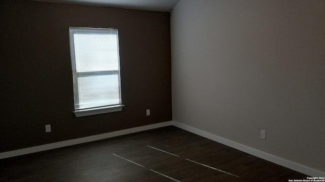 empty room featuring dark wood-type flooring