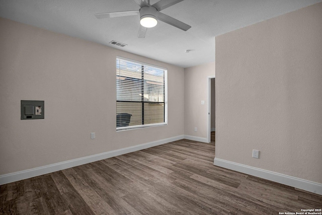 spare room with hardwood / wood-style flooring and ceiling fan