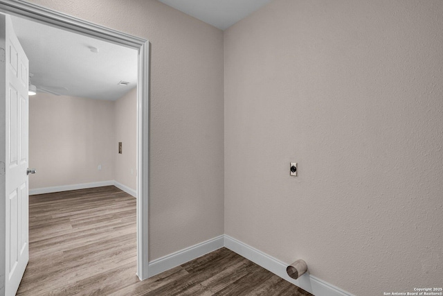 laundry area with electric dryer hookup and light hardwood / wood-style flooring