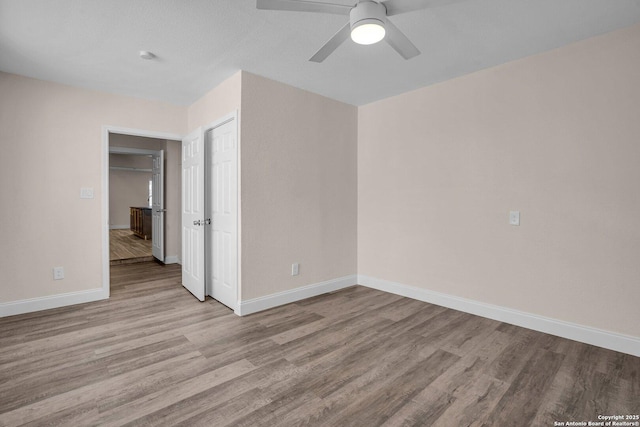 empty room featuring ceiling fan and light hardwood / wood-style floors