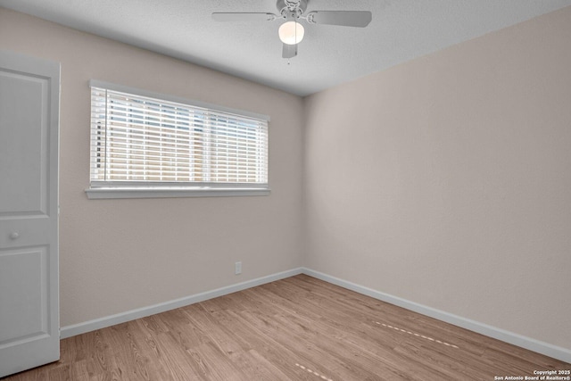 empty room with light hardwood / wood-style floors and ceiling fan