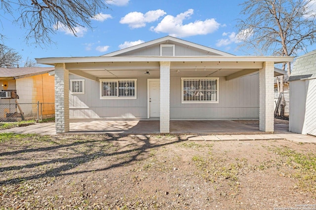 back of house featuring a carport