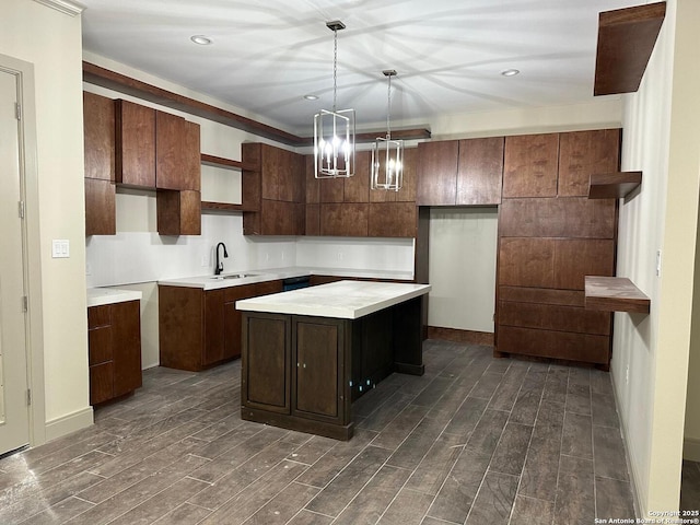 kitchen featuring dark brown cabinetry, hanging light fixtures, sink, and a center island