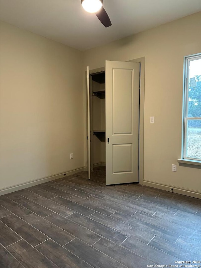 unfurnished bedroom featuring ceiling fan and a closet