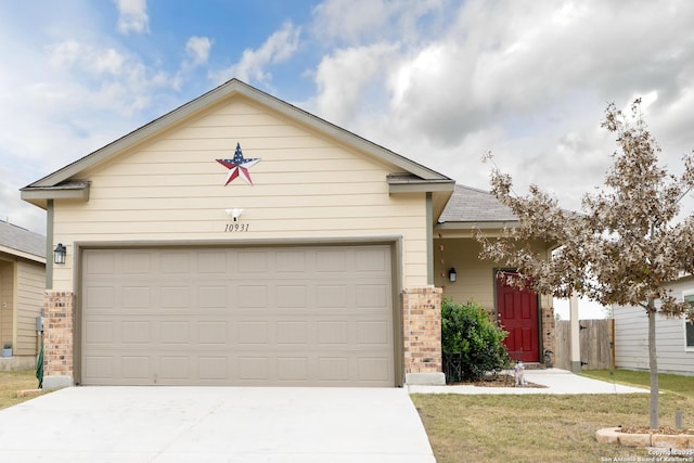 view of front of property featuring a garage and a front lawn