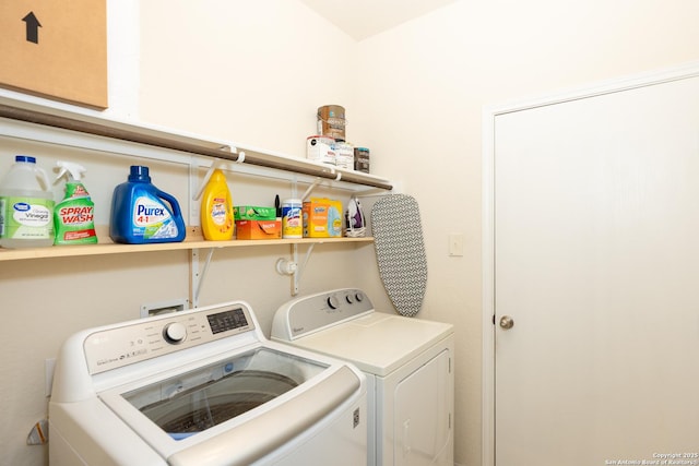 clothes washing area with washer and clothes dryer