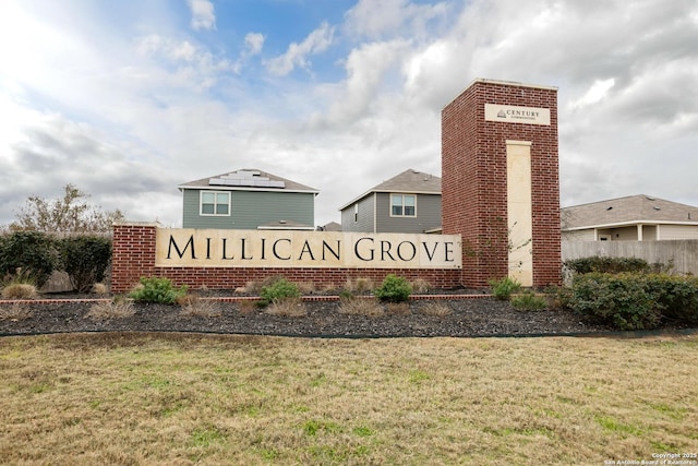 community / neighborhood sign with a lawn