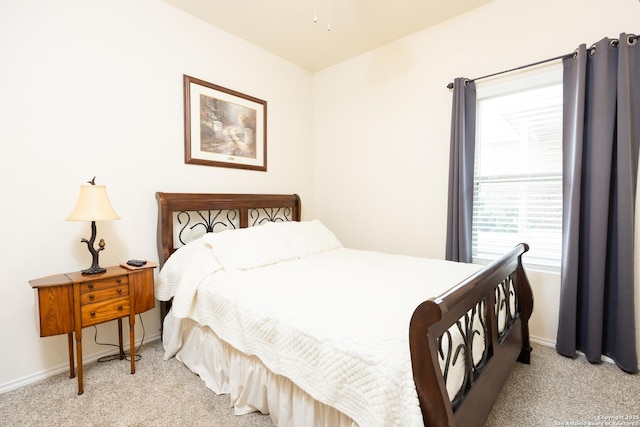 bedroom featuring light carpet