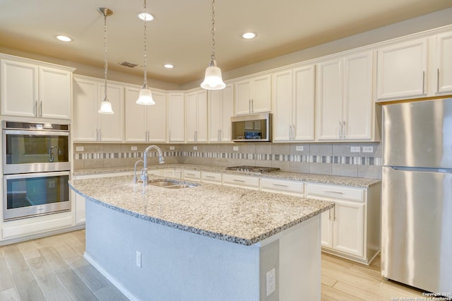 kitchen featuring appliances with stainless steel finishes and white cabinets