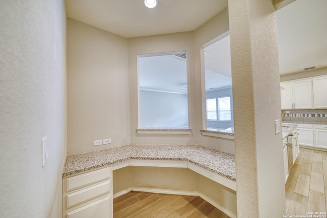 unfurnished dining area with built in desk