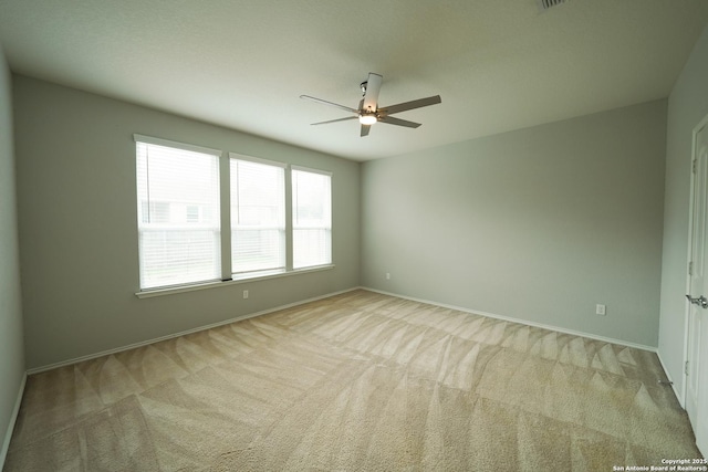 spare room with light carpet and ceiling fan