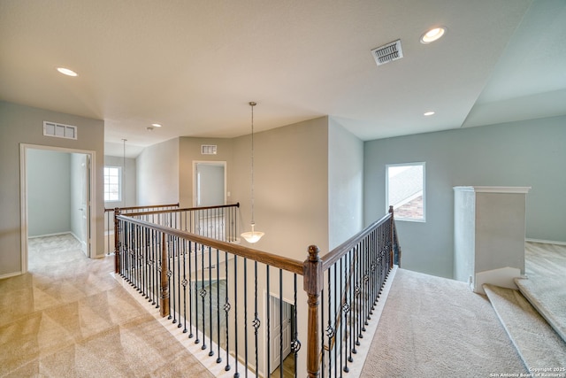 hallway with light colored carpet