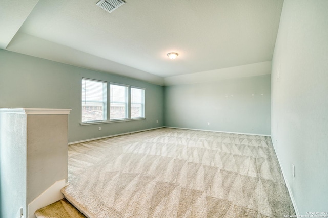 unfurnished room featuring light carpet