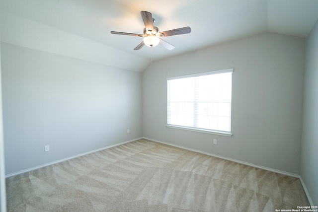 carpeted empty room with ceiling fan and vaulted ceiling