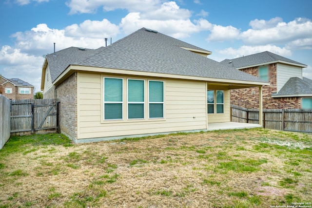 rear view of property with a lawn and a patio area