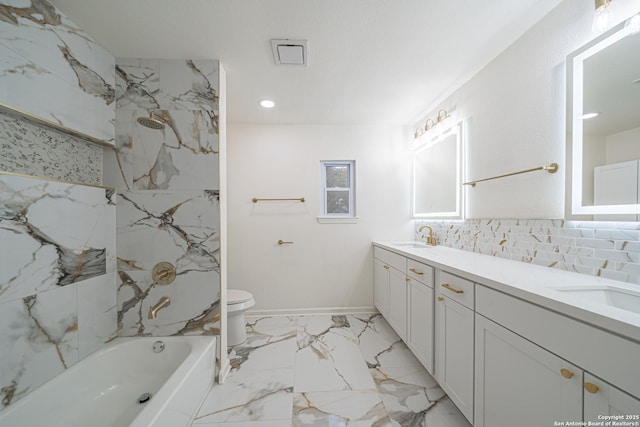 full bathroom featuring tasteful backsplash, vanity, tiled shower / bath combo, and toilet