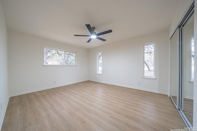 empty room with ceiling fan and light wood-type flooring