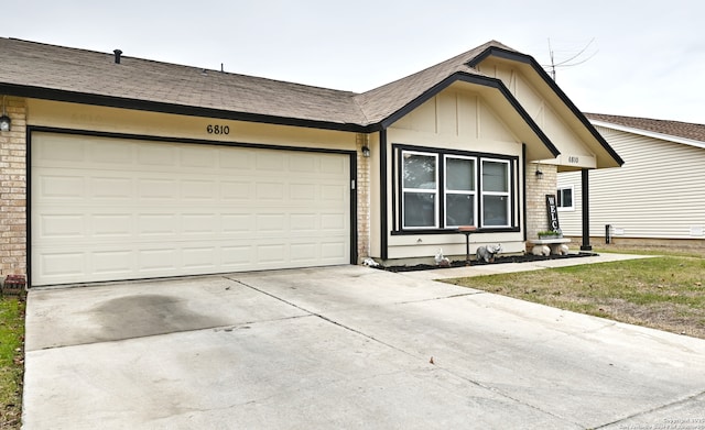 single story home with a garage and a front lawn