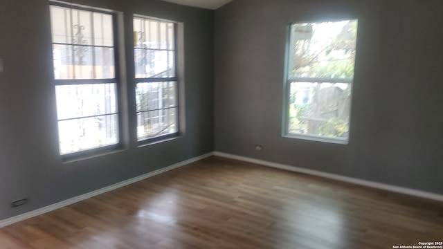 unfurnished room featuring hardwood / wood-style floors