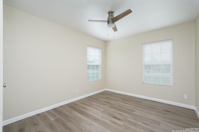 spare room with ceiling fan and light hardwood / wood-style flooring