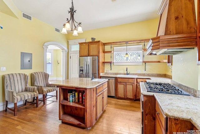 kitchen featuring open shelves, visible vents, appliances with stainless steel finishes, a sink, and electric panel