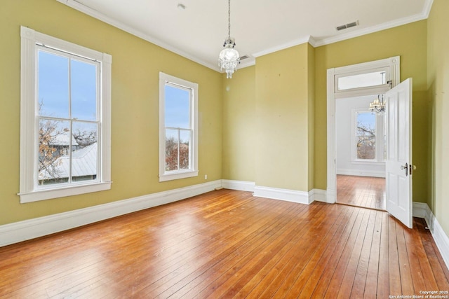 unfurnished dining area with ornamental molding, visible vents, and a notable chandelier